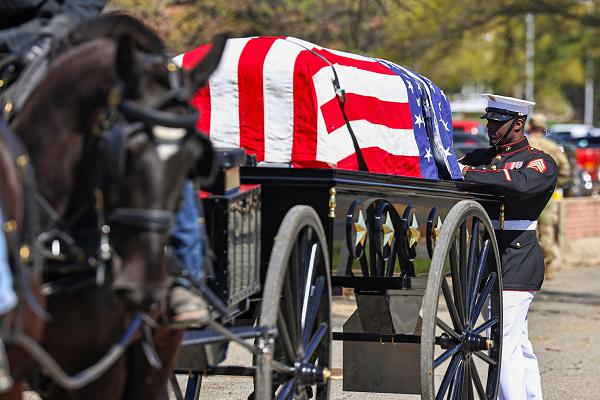 U.S. Marine Corps Sgt. Joshua Williams, body bearer, Marine Barracks Washington, straps in a training casket as a part of caisson refamiliarization training with training caskets at Fort Myer-Henderson Hall, Virginia, April 9, 2025. This opportunity prepares the Body Bearers to support the Army's return to using horse-drawn caissons for funerals at Arlington National Cemetery starting in June. The use of horse-drawn caissons for funerals is a long-standing tradition, with the Marines working alongside the Army to honor fallen service members. Caisson training prepares the Body Bearers to carry out their solemn duty with the dignity and precision the mission demands (U.S. Marine Corps photo by Lance Cpl. Christopher Prelle)