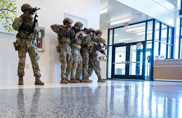 Airmen from the 633rd Security Forces Squadron clear the lower level of a hospital during an active shooter training exercise at Joint Base Langley-Eustis, Va., April 17, 2025. The scenario simulated a coordinated threat inside a medical facility, requiring Airmen to methodically move  through hallways and rooms to secure the area and neutralize hostiles. (U.S. Air Force photo by Senior Airman Mikaela Smith) 