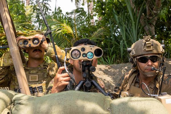 Australian Army officer Lt. Benjamin Buchanon, a Royal Australian Artillery Fire Support Officer, left, Philippine Airman Sgt Edmond V. Quimson Jr. with 710th Special Operations Wing,  and U.S. Marine Corps Sgt. Ceasar Luna, a joint terminal attack controller with 1st Air Naval Gunfire Liaison Company, Marine Rotational Force – Darwin 25.3, observe a target during a close-air support rehearsal during Exercise Balikatan 25, April 26, 2025. Balikatan is a longstanding annual exercise between the U.S. and Philippine armed forces designed to strengthen the alliance, showcase the capable combined force, and demonstrate the commitment to regional security and stability. (U.S. Marine C5rps photo by Sgt, Ezekieljay Correa)