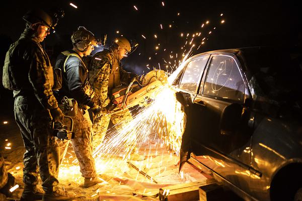 U.S. Marines with Marine Wing Support Squadron (MWSS) 372 cut into a staged vehicle during a tactical recovery of aircraft and personnel course hosted by the Amphibious Raids Branch, Expeditionary Operations Training Group, I Marine Expeditionary Force, at Marine Corps Base Camp Pendleton, California, May 15, 2025. The Amphibious Raids Branch of EOTG provides relevant and realistic training to Marine small-unit leaders in mission-essential tasks to prepare units for deployment. (U.S. Marine Corps photo by Sgt. Bryant Rodriguez)
