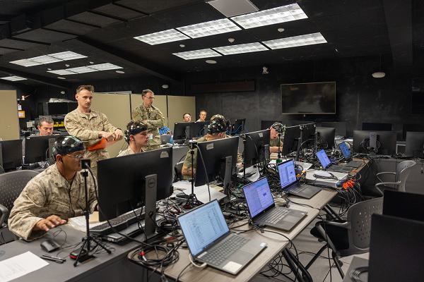 U.S. Marines with 3rd Light Armored Reconnaissance Battalion, 1st Marine Division, I Marine Expeditionary Force, participate in a simulated training at the Battle Simulation Center, Marine Corps Air Ground Combat Center, Twentynine Palms, California, April 8, 2025. The Defense Advanced Research Project Agency’s partnership with MAGTFTC’s BSC and 1st MARDIV units represents a long-term investment in gaining a strategic edge by developing performance metrics for Fire Support Team training and enhancing systems like the  Joint Terminal Attack Controller Virtual Trainer. (U.S. Marine Corps photo by Cpl. Anna Higman)