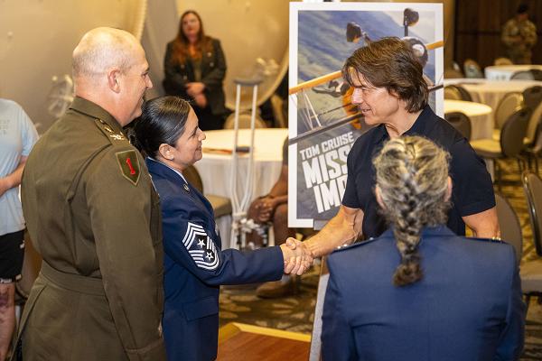 Actor Tom Cruise greets U.S. Air Force Chief Master Sgt. Gilda Alexander, command chief of Joint Base San Antonio and the 502nd Air Base Wing, and U.S. Army Col. Will B. Freds, deputy commander of JBSA and the 502nd Air Base Wing, during a reception with leadership from across JBSA at Hotel Emma, San Antonio, Texas, May 22, 2025. Cruise visited with JB San Antonio leadership and service members to thank them for their sacrifices in support of the mission. (U.S. Air Force photo by Senior Airman Gabriel Jones) 
