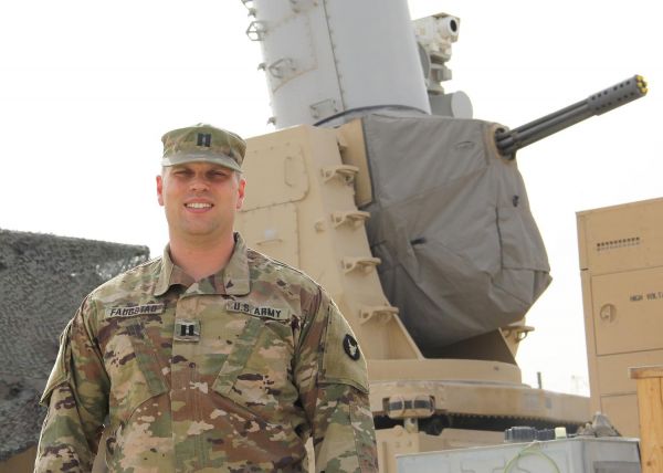 Capt. Thackery Faugstad of Lakeville, Minn., acting executive officer of Headquarters and Headquarters Battery, 1st Battalion, 194th Field Artillery, 2nd Infantry Brigade Combat Team, Iowa Army National Guard, in front of his battery’s land-based phalanx weapon system (LPWS) at an undisclosed location in the U.S. Central Command (CENTCOM) area of operations on May 12, 2021. Faugstad earned a doctorate while deployed.