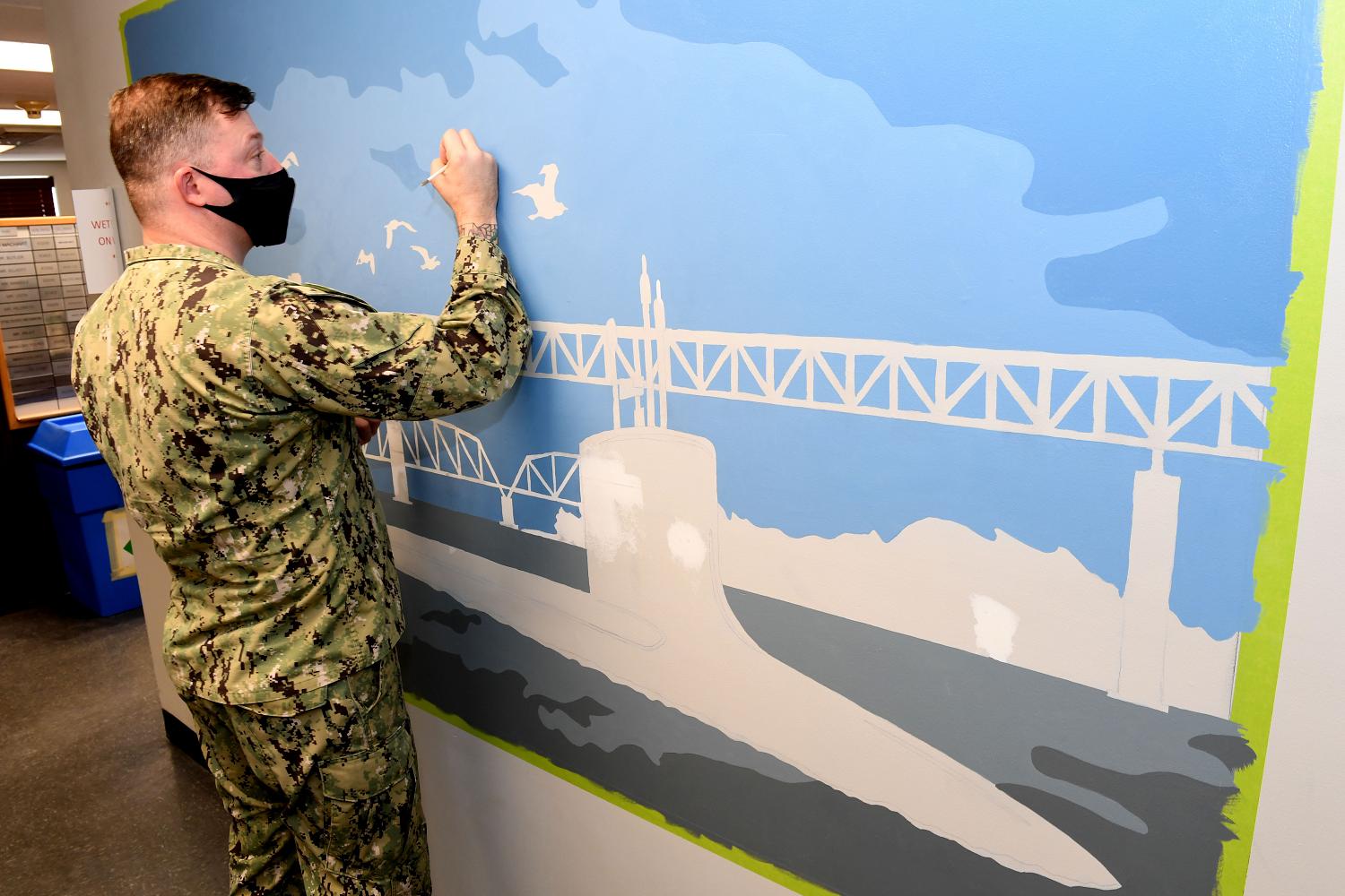 210224-N-GR655-057 GROTON, Conn. (February 24, 2021) – Petty Officer 1st Class Jamie Pearson, a Machinist’s Mate (Auxiliary) assigned to Naval Submarine Support Facility New London, paints a mural on an office wall at his command. Pearson has been moonlighting as an artist on and off base in the Groton community since 2014. (photo by Chief Petty Officer Joshua Karsten/RELEASED)