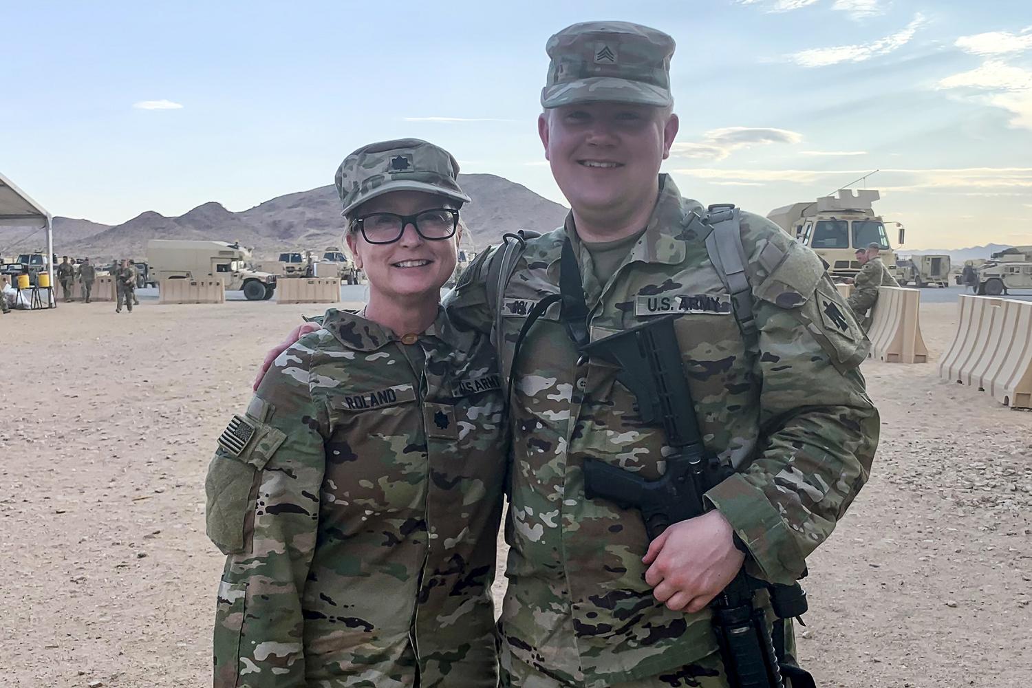 Lt. Col. Tanya Roland and her son, Sgt. Paul Roland, serve together in the 45th IBCT during a rotation at the National Training Center in Fort Irwin, CA, July 11, 2021. Tanya Roland, the 45th IBCT judge advocate, transferred to the Oklahoma Army National Guard in November 2020 after nearly 18 years of service with the United States Army Reserve. Paul Roland, religious affairs specialist for Headquarters Battery, 1st Battalion, 160th Field Artillery Regiment, has been in the Oklahoma Army National Guard for seven years. (Oklahoma Army National Guard photo by Maj. Lee Sargent)