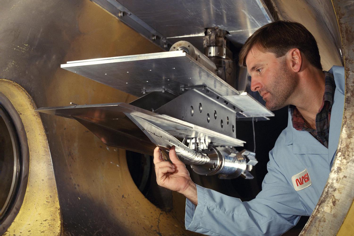 J. Conover with the front/side view of the inlet. Photographed in the Arc-Heated Scramjet Test Facility (AHSTF), building 1247B.NASA Identifier: L98-2288