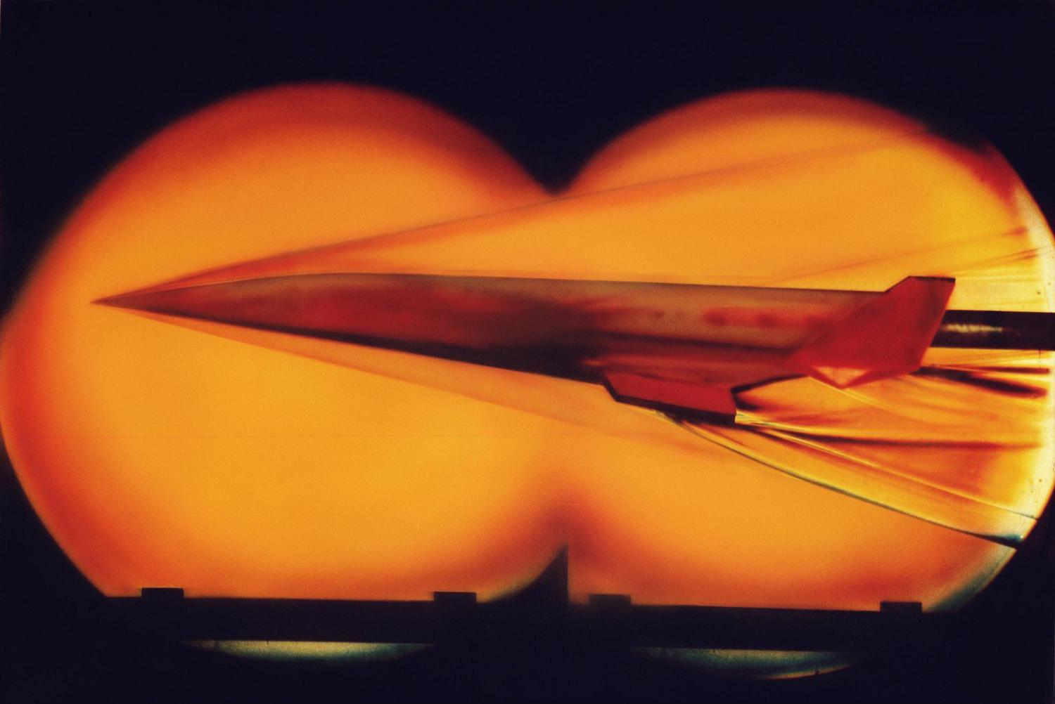 A model hypersonic craft undergoing tests in the 20 Inch Mach 6 Tunnel. Photograph published in Winds of Change, 75th Anniversary NASA publication, (pages 114-115), by James Schultz.