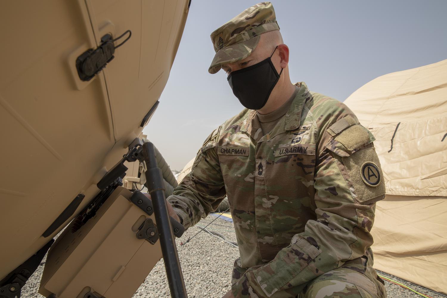 Army Master Sgt. Brian Chapman, Information Systems Division Non-commissioned Officer in Charge for U.S. Army Central G6 adjusts their Tampa 1.3M satellite dish during validation for the new Relocatable Emergency Command Post at Camp Arifjan, Kuwait, April 12 2021. This technology further develops the capabilities and increases the U.S. Armed Forces overall readiness. (Photo by Sgt. Robert Torres)