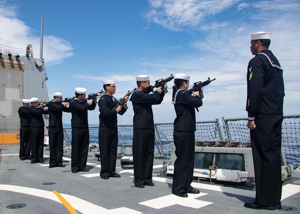 ATLANTIC OCEAN (June 13, 2021) The Arleigh Burke-class guided-missile destroyer USS Lassen (DDG 82) firing detail fires a volley during a burial at sea ceremony on the ship's flight deck, June 13, 2021. Lassen is underway in the Atlantic Ocean supporting USS Gerald R. Ford's (CVN 78) full ship shock trials. The U.S. Navy conducts shock trials of new ship designs using live explosives to confirm that our warships can continue to meet demanding mission requirements under harsh conditions they might encounter in battle. (Photo by Mass Communication Specialist 3rd Class Zachary Melvin)