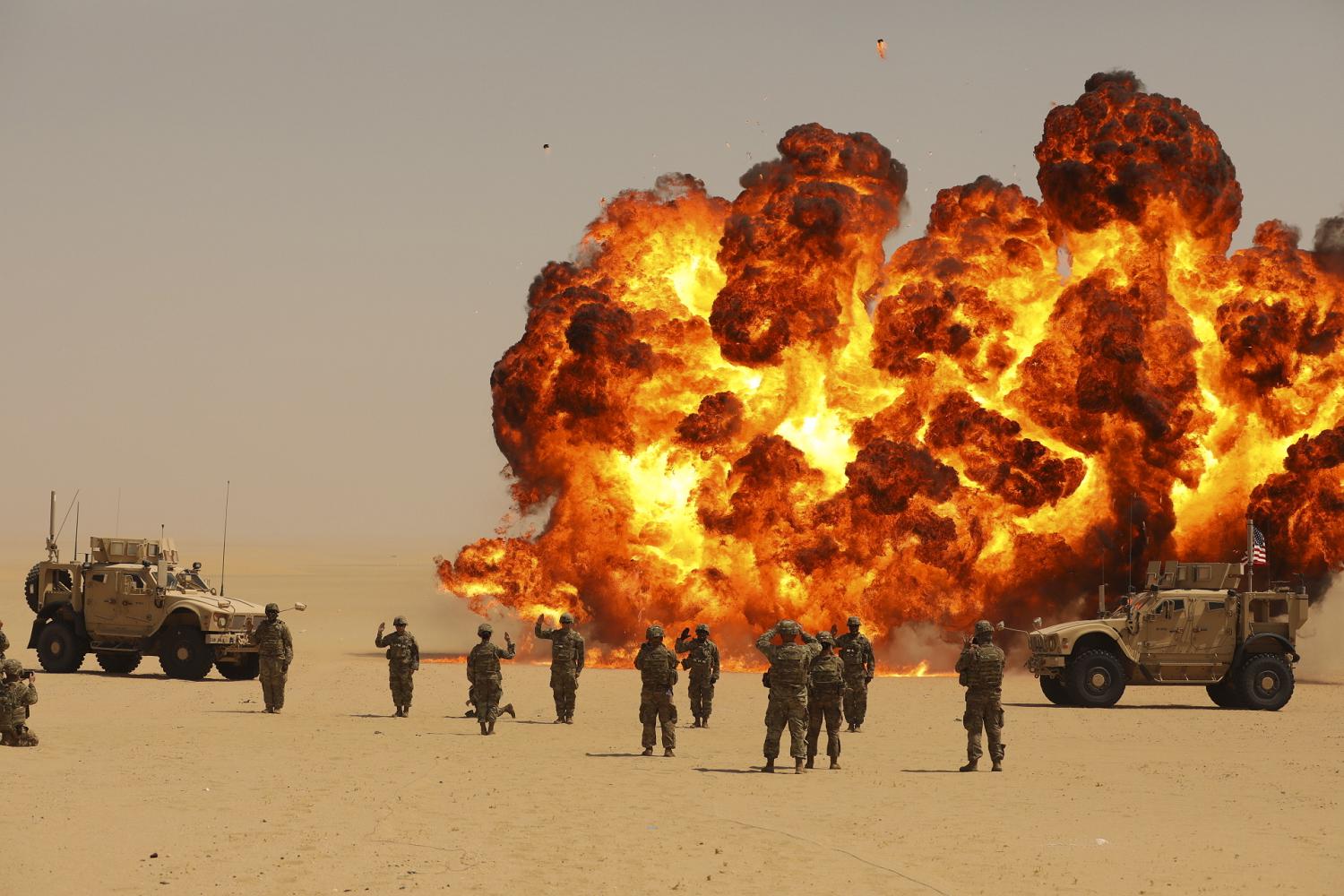 A mass re-enlistment for Soldiers with the Division Special Troops Battalion, 3rd Division Sustainment Brigade and 541st Combat Sustainment Support Battalion, was held on an Explosive Ordnance Disposal Range at Camp Buehring, Kuwait, Sept. 8, 2021. A "fireball" detonation was constructed to make the re-enlistment more memorable. (photo by Spc. Elorina Santos, 3DSB Public Affairs)