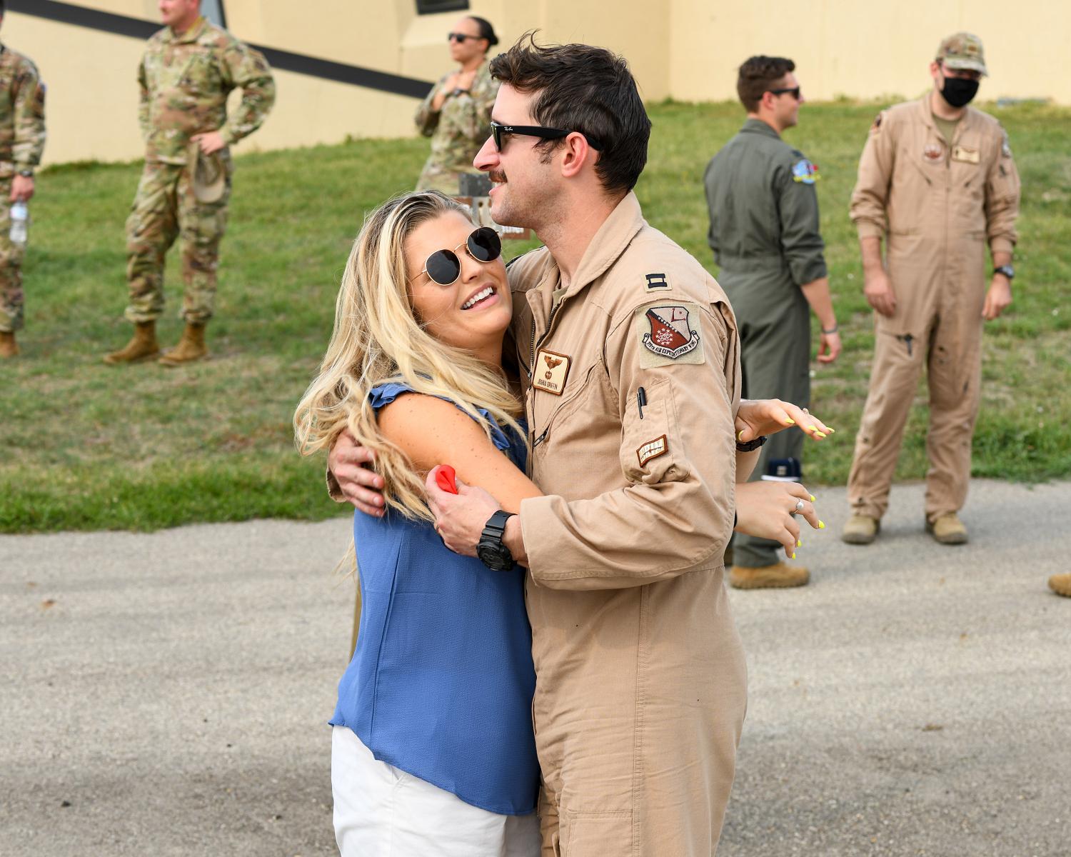 Spouses reunited with thier husbands who have safely returned from deployment at Minot AFB, ND, Sept. 10, 2021. The aircrews that arrived were from the 23rd Bomb Squadron. (photo by Airman 1st Class Saomy Sabournin)