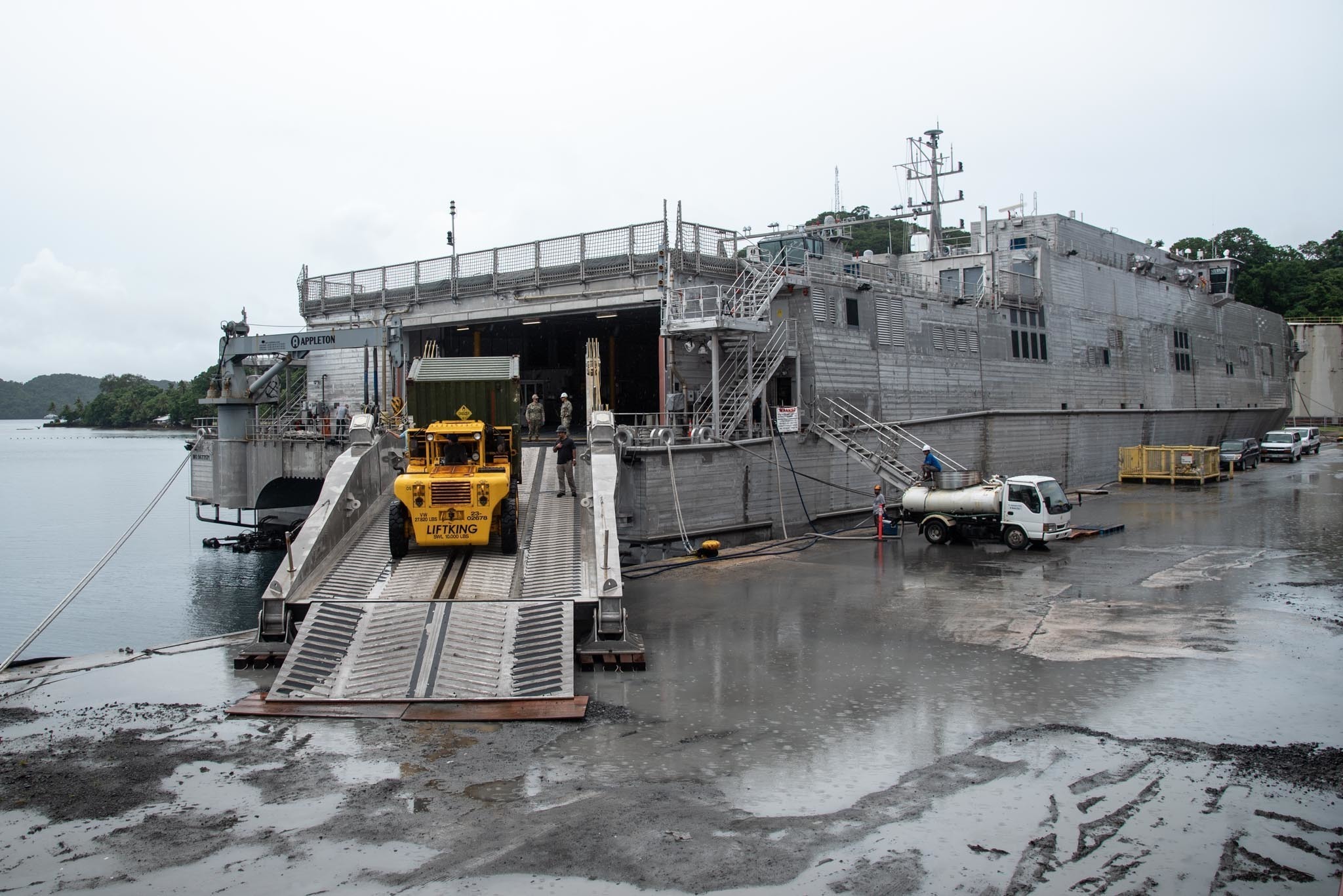 MALAKAL ISLAND KOROR, Palau (Sep. 23, 2021) A container of Lightweight Water Purification Systems (LWPS) is offloaded off of the Spearhead-class expeditionary fast transport USNS City of Bismarck (T-EPF-9) at the Port of Palau to demonstrate Seabee capabilities in support of fleet operations. LWPS provide freshwater redundancy at austere harbors with no potable water. NMCB 1 is forward-deployed to execute construction, humanitarian assistance, theater security cooperation, and support Fleet maneuver in the U.S. 7th Fleet areas of operation. (U.S. Navy photo by Steelworker 3rd Class Taylor Myers)