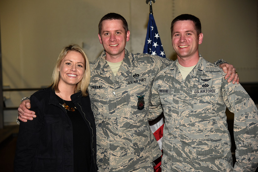 Air Force Tech. Sgt. Christopher Engelke, a regional dispatch center superintendent for the 721st Civil Engineer Squadron, his wife, Jenna-Brie Engelke, and his twin brother, Air Force 1st Lt. Cody Engelke, the deputy commander of training for the 18th Space Control Squadron, embrace after Chris’s reenlistment at Cheyenne Mountain Air Force Station, Colo., March 8, 2018. Air Force photo by Robb Lingley