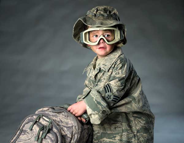 Casen Fairfax, son of Staff Sgt. Aaron Fairfax, is captured while wearing his father’s uniform. U.S. Air Force photo by Staff Sgt. Vernon Young Jr.