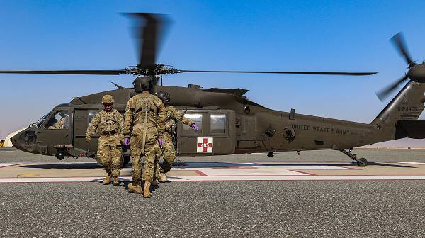 U.S. Army Soldiers assigned to the 2-211th General Support Aviation Battalion, Minnesota Army National Guard, and the 155th Armored Brigade Combat Team, Mississippi Army National Guard, pull a patient from a UH-60L Black Hawk helicopter during an aeromedical evacuation rehearsal at Camp Buehring, Kuwait, Dec. 11, 2018. (Photo by Sgt. Emily Finn)