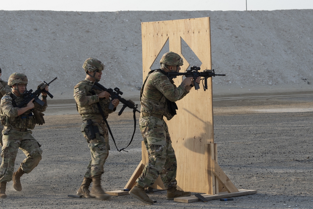 380th Expeditionary Security Forces Squadron Airmen fire from behind a barrier during a simunition proficiency firing course.  Al  Dhafra hosted the first course of this kind in the U.S. Air Forces Central Command area of responsibility to align with the line of effort to increase lethality, as well as allowing Defenders to maintain proficiency with their weapon.