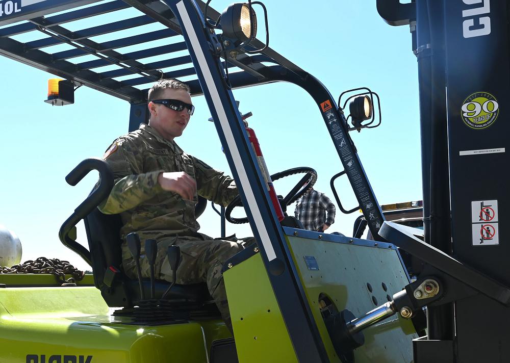 Spc. Andre St. Laurent, Headquarters and Service Company, 3643d Brigade Support Battalion, New Hampshire Army National Guard, loads freight in Concord, April 24, 2020. St. Laurent is one of 15 Guard members supporting COVID-19 relief efforts at a warehouse distribution center for the state's cache of personal protective equipment. (Photo by Staff Sgt. Charles Johnston)