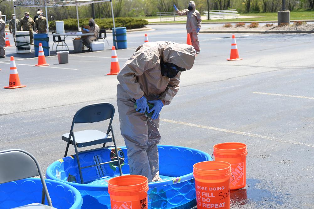 Citizen-Soldiers and Citizen-Airmen from the Wisconsin National Guard collect specimens for COVID-19 testing May 13, 2020, at Burlington High School in Burlington, Wisconsin. The Wisconsin National Guard has 25 specimen collection teams operating throughout the state.