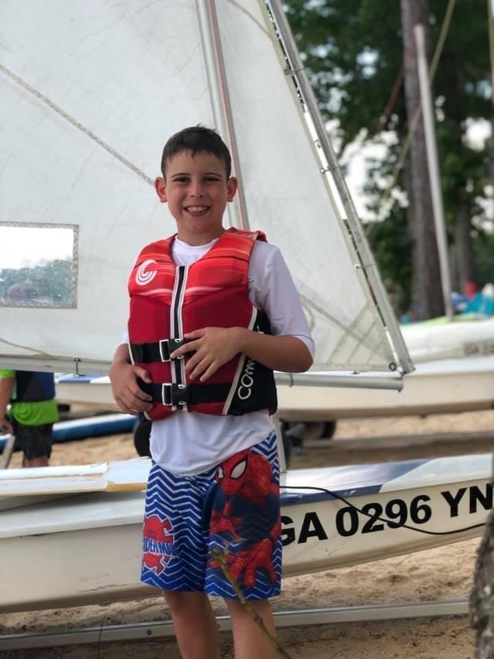 Grant Dietert Jr., 10, poses with his sailboat before an event hosted by the Augusta Sailing Club at Clarks Hill Lake. (Courtesy photo)