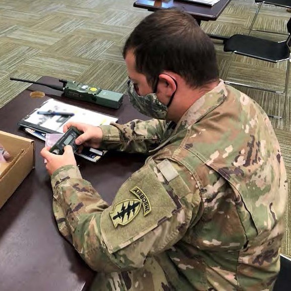 Special Forces at U.S. Army Special Operations Command Headquarters, Fort Bragg, North Carolina, initialize their new Tactical Key Loader as part of a new equipment training class in March 2021, where they loaded the cryptographic keys onto tactical radios. The Army procured and developed the TKL specifically for Special Operations teams due its smaller and dimmer screen to reduce light during nighttime operations and its simple one-button operation to fill the key slots. (photo by Phillip D. Greer)