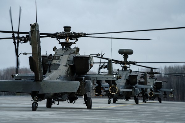 Nearly 20 AH-64D Apache Longbow helicopters assigned to 1-3rd Attack Battalion, 12th Combat Aviation Brigade, arrive at Lielvarde Military Airfield, Latvia, Feb. 24, 2022. Elements of the 12 CAB departed Germany for Lithuania and Latvia to conduct training with NATO allies in support of Saber Strike 22. 12 CAB trains and remains a constant and credible U.S. Army aviation force in support of allies and partners and the stability and security of Europe. (photo by Staff Sgt. Thomas Mort)