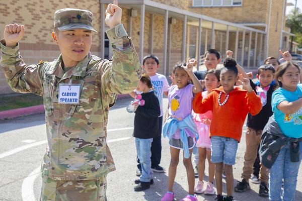 Spc. Chao Yang, an information technology specialist assigned to Headquarters Support Company, Headquarters and Headquarters Battalion, U.S. Army South, teaches students drill and ceremony during career day at Booker T. Washington Elementary School in San Antonio, Texas, March 8, 2024. U.S. Army South Soldiers provided demonstrations and presentations of various facets of Army life during the school’s annual event.(U.S. Army photo by Staff Sgt. ShaTyra Cox)