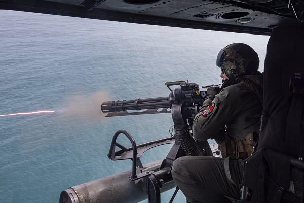 U.S. Marine Corps Gunnery Sgt. Parrish Hall II, a native of Michigan and a UH-1Y Venom crew chief with Marine Light Attack Helicopter Squadron (HMLA) 167, fires a GAU-17A minigun during a flight over the coast of North Carolina, March 26, 2024. HMLA-167 conducted precision-guided munitions delivery to familiarize designated pilots and ordnance personnel with proper procedures for firing and handling multiple ordnance types. The live-fire training allowed HMLA-167 to enhance integration with the joint force while training in aviation operations in maritime-surface warfare. (U.S. Marine Corps photo by Lance Cpl. Orlanys Diaz Figueroa)
