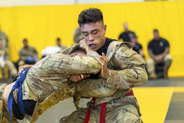 Soldiers compete during the second day of the 2024 Lacerda Cup Combatives Championship in the Quarter Finals April 11, 2024, at Smith Gym, Fort Moore, Ga. The U.S. Army Combatives Program enhances unit combat readiness by building Soldiers' personal courage, confidence, and resiliency as well as their situational responsiveness to close quarters threats in the operational environment. (U.S. Army photo by Daniel Marble)