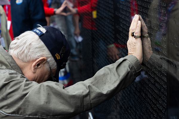 240427-N-GC965-3132 WASHINGTON (April 27, 2024) A Naval Special Warfare (NSW) Vietnam veteran places his hand on The Moving Wall at the Vietnam Veterans Memorial during Honor Flight San Diego’s “Tour of Honor,” April 26-28. A small group of former SEALs and members of Naval Special Warfare’s (NSW) active force volunteered to serve as “guardians” for 90 NSW Vietnam veterans on a three-day trip to Washington, D.C., honoring their service and visiting the memorials built for their sacrifice. The trip included visits to the WW II, Lincoln, Korea, Vietnam, Navy, and Marine Corps Memorials and Arlington National Cemetery, all arranged by the Honor Flight Network. NSW is the nation’s premiere maritime special operations force and is uniquely positioned to extend the fleet’s reach and deliver all-domain options for naval and joint force commanders. (U.S. Navy photo by Mass Communication Specialist 1st Class Ramon Go)
