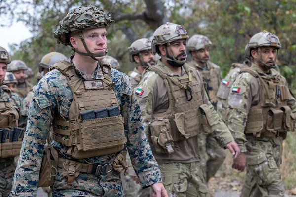 U.S. Marine Corps Cpl. Ender Wichlacz, left, a team leader with 3rd Battalion, 1st Marine Regiment, 1st Marine Division, hikes alongside members of the United Arab Emirates Presidential Guard during a bilateral training exercise at Marine Corps Base Camp Pendleton, California, May 10, 2024. As part of the training, Marines and the Emirati soldiers conducted progressive training on reconnaissance tasks, counterinsurgency operations, and individual skills training in order to improve small unit tactical proficiency and interoperability, and maintain a bilateral military relationship. Wichlacz is a native of Minnesota. (U.S. Marine Corps photo by Lance Cpl. Alexis Ballin)