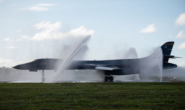 A U.S. Air Force B-1B Lancer from the 37th Expeditionary Bomb Squadron receives a bath upon landing at Andersen Air Force Base, Guam, June 3, 2024, in support of a Bomber Task Force mission. BTF missions demonstrate lethality and interoperability in support of a free and open Indo-Pacific. (U.S. Air Force photo by Airman 1st Class Audree Campbell) 