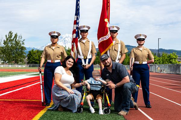 Arlan Russell and his parents pose for a photograph with a Marine Corps color guard at the conclusion of his Honorary Marine ceremony at Orting Middle School in Orting, Wash., June 8, 2024. The title of Honorary Marine is an honor bestowed by the Commandant of the Marine Corps to civilians who have made extraordinary contributions to the Marine Corps. The program began in 1992 and is intended to strengthen the bond between the American people and the Marine Corps. Notable Honorary Marines include Chuck Norris, Gary Sinise, and Joe Rosenthal. Russell is the 109th person to earn the title of Honorary Marine. (U.S. Marine Corps photo by Staff Sgt. Courtney G. White)