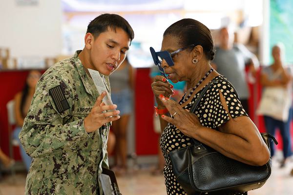 240719-N-WP746-1151LIMÓN, Costa Rica (July 19, 2024) – Hospital Corpsman 3rd Class Jefferson Arpi Ordóñez assesses a patient’s vision in a temporary medical facility at the port of Limón, Costa Rica, during Continuing Promise 2024. Continuing Promise has long been and will continue to be a way for nations in the Americas to form stronger cultural and social bonds, leading to stronger regional partnerships. (U.S. Navy photo by Chief Mass Communication Specialist Mark Logico)