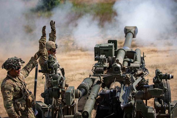 U.S. Army Sgt. Jose Ochoa and Spc. Joseph Travino, cannon crew from the 1st Battalion, 160th Field Artillery Regiment, Oklahoma Army National Guard, perform direct fire with a M777A2 howitzer using 155mm rounds in conjunction with foreign national allies during Exercise Northern Strike 24-2 at Camp Grayling, Michigan, Aug. 7, 2024. Northern Strike 24-2, one of the Department of Defense's largest reserve component readiness exercises, is scheduled to take place at Michigan's National All Domain Warfighting Center (NADWC) from August 3-17, 2024. Over 6,300 participants from 32 states and territories and several international participants will converge at the NADWC. Northern Strike is the premier reserve component training event designed to build readiness with joint and partner forces in all domains of warfare. (U.S. Air National Guard photo by Airman 1st Class Jordaan Kvale)