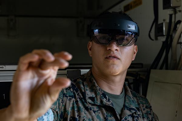 U.S. Marine Corps Cpl. Vradley Cerna, from Texas, a digital wideband systems maintainer with Marine Wing Communications Squadron (MWCS) 28, tests tele-maintenance capabilities at Marine Corps Air Station Cherry Point, North Carolina, Aug. 21, 2024. Marine Depot Maintenance Command is experimenting with augmented reality technology as part of its effort to modernize its maintenance capabilities from industrial-era practices to technologies suitable and capable of meeting the demands of the Information Age. (U.S. Marine Corps photo by Lance Cpl. Orlanys Diaz Figueroa)