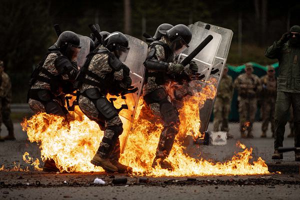 Flames from a Molotov cocktail engulf U.S. Soldiers participating in Fire Phobia training in Hohenfels, Germany, Sept. 28th, 2024. Fire Phobia training allows Soldiers to familiarize themselves with effective tactics and techniques for reacting to and mitigating the threats of improvised incendiary devices such as a Molotov cocktail. (US Army National Guard photo by Staff Sgt. Mickey Miller)