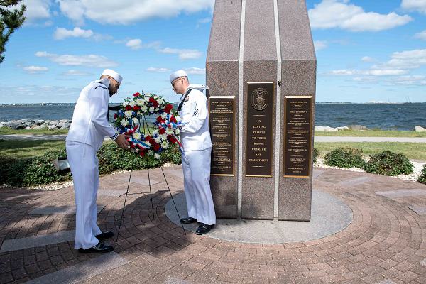 Logistics Specialist 2nd Class Wilfredo Cerezo-Rodriguez and Logistics Specialist 1st Class Robert Jordan lay a wreath at the USS Cole (DDG 67) Memorial on Naval Station Norfolk, Oct. 10, 2024. The wreath was laid in honor of the 24th anniversary of the Oct. 12, 2000 terrorist attack that killed 17 Sailors aboard the guided-missile destroyer USS Cole (DDG 67) in Aden Harbor, Yemen. (U.S. Navy photo by Mass Communication Specialist 1st Class Sophie A. Pinkham)               