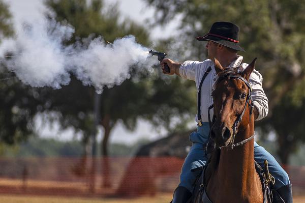 U.S. Army Staff Sgt. Ethan Cizauskas, a member of the 1st Infantry Division's Commanding General's Mounted Color Guard, particpates in the mounted pistol competition at the National Cavalry Competition in El Reno, Oklahoma on Sept. 12, 2024. Competitors had to ride horseback over and through obstacles while shooting specified targets along the course. (U.S. Army photos by Spc. Mackenzie Striker)