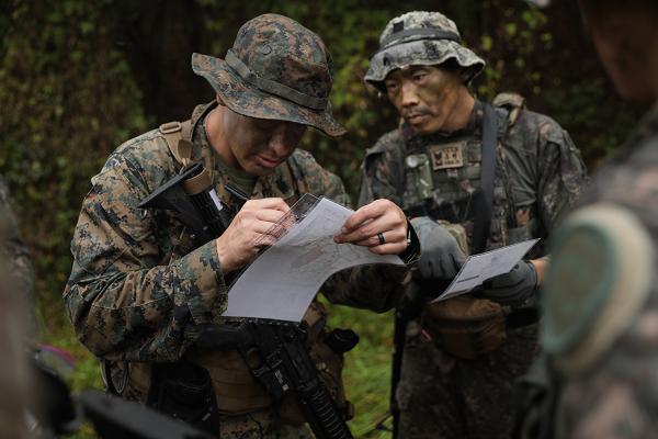 A squad of U.S. and Republic of Korea Army Soldiers plot grid coordinates during the land navigation event as part of Mangudai 2024, October 22, at Camp Bonifas, Republic of Korea. The annual mangudai training event brings together senior enlisted members from across the Korean Peninsula to engage in squad based training events that builds joint camaraderie and reinforces their mastery of fundamental Soldiering tasks. (U.S. Army Photo by Staff Sgt. Ian Vega-Cerezo, USFK Public Affairs)