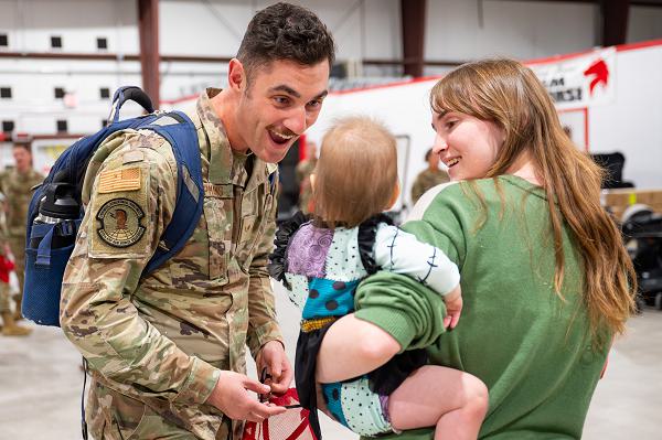Senior Airman Samuel Koopmans, 819th Rapid Engineer Deployable Heavy Operational Repair Squadron engineer, reunites with his loved ones Oct. 8, 2024, at Malmstrom Air Force Base, Mont. Members of the 819th RHS returned home from a six-month deployment to Andersen Air Force Base, Guam where the Airmen teamed up with U.S. Navy Seabees to assess and prepare the WWI-era Tinian airfield for paving. (U.S. Air Force photo by Senior Airman Mary Bowers)  
