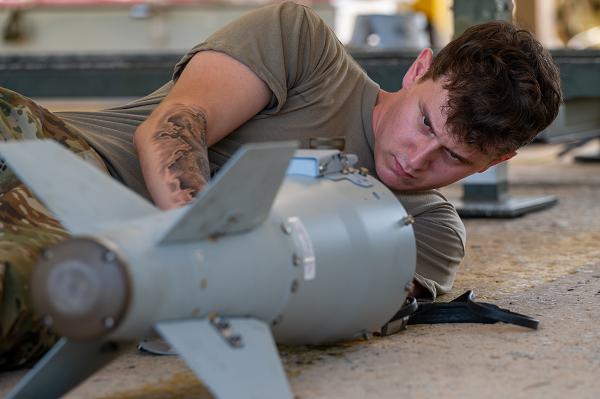 U.S. Air Force Airman 1st Class Tanner England, 18th Munitions Squadron munitions support equipment maintenance technician, readies the wiring on the inside of a joint direct attack munition guidance tail kit component during bomb building training at Kadena Air Base, Japan, Oct. 22, 2024. Each piece of the JDAM must be thoroughly inspected and prepared before its installation on unguided, general-purpose munitions. (U.S. Air Force photo by Senior Airman Luis E. Rios Calderon)  