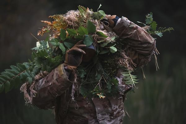 U.S. Army Spc. Drew Topp, a sniper with Headquarters and Headquarters Company, 3rd Battalion, 161st Infantry Regiment, 81st Stryker Brigade Combat Team, Washington National Guard, exits the wood line following an infiltration stalk lane on Joint Base Lewis-McChord, Wash., Oct. 19, 2024. Snipers were dropped at designated grid points and then moved forward towards two observers, using natural vegetation to avoid detection. (U.S. Army National Guard photo by Staff Sgt. Adeline Witherspoon)