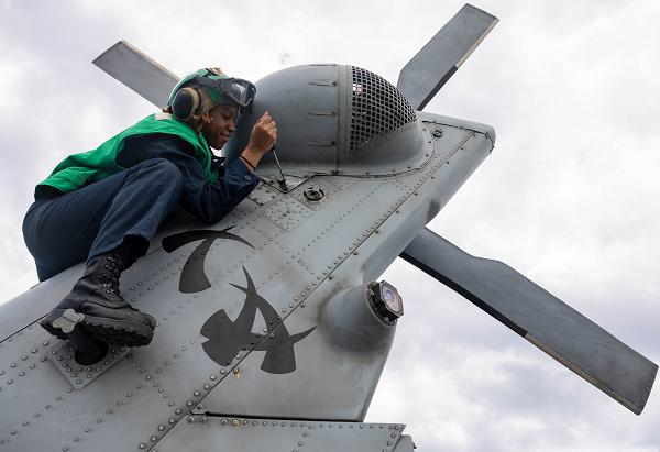 Aviation Structural Mechanic 2nd Class Kristiana Tyler, from Broken Arrow, Oklahoma, assigned to Helicopter Maritime Strike Squadron (HSM) 51, installs a tail fastener to an MH-60R Sea Hawk on the flight deck of the Arleigh Burke-class guided-missile destroyer USS Preble (DDG 88) in the Philippine Sea, Nov. 30, 2024. Preble is forward-deployed and assigned to Destroyer Squadron (DESRON) 15, the Navy's largest DESRON and the U.S. 7th Fleet's principal surface force. (U.S. Navy photo by Mass Communication Specialist 1st Class Ryre Arciaga)                                              