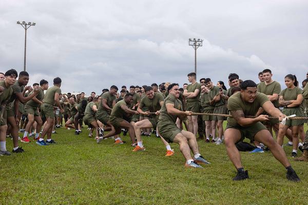 U.S. Marines and Sailors with Combat Logistics Regiment 37, 3rd Marine Logistics Group, compete in tug-of-war contest during a Turkey Bowl on Camp Kinser, Okinawa, Japan, Nov. 22, 2024. The event was held to foster holiday spirit and camaraderie through friendly competition. (U.S. Marine Corps photo by Lance Cpl. Aaliyah Hunt)