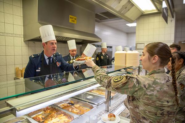 Service members, employees, and staff from Landstuhl Regional Medical Center attend a Thanksgiving meal served by senior leaders and commanders at Landstuhl, Germany, on Nov. 20, 2024. The event was held to show appreciation for their dedication and support of the mission to provide world-class care to the Kaiserslautern Military Community. (DoD photo by Travis Jones)