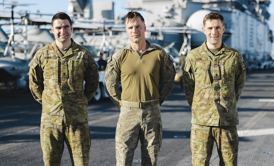 three austrailian men stand at parade rest