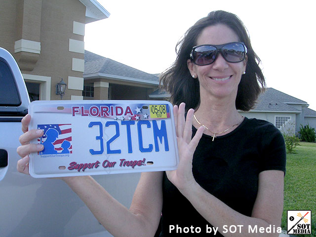 Janet [ ] shows off her Support Our Troops! license plate! 