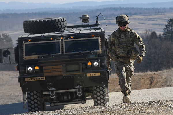 GRAFENWOEHR, BY, GERMANY, March 11, 2022-  A U.S. Soldier, assigned to 41st Field Artillery Brigade, ground guides a Heavy Expanded Mobility Tactical Truck