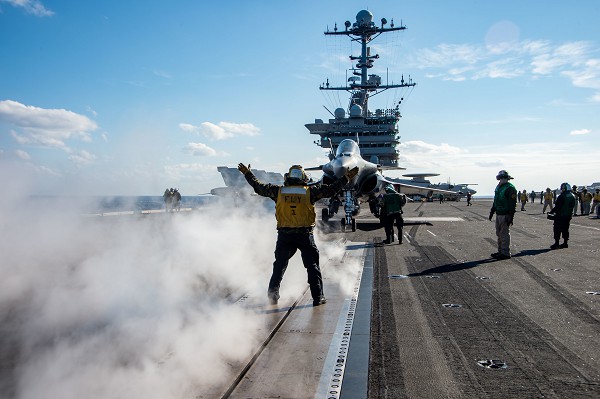IONIAN SEA, March 11, 2022 - Aviation Boatswain's Mate (Handling) 2nd Class John Gandy, from Waco, Texas, directs the pilot of a French Rafale F-3R on the flight deck of the Nimitz-class aircraft carrier USS Harry S. Truman