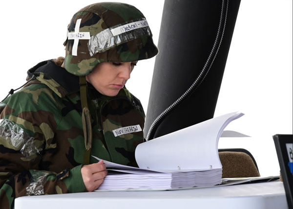 Berry Field Air Base, April 7, 2022 – U.S. Air Force 1st Lt. Rachel Shearin, a nurse with the 118th Medical Group, reads through a medical manual in a deployment situation April 7, 2022 at Berry Field Air National Guard Base, Nashville, Tennessee. Members from across the 118th Wing took part in the largest on-base readiness exercise in wing history April 5-9, to help prepare and train the wing for a near-peer conflict.  Photo by Staff Sgt. Jordan Harwood